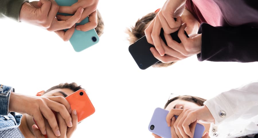 Teenagers using smartphones to access social media sites in Virginia Beach