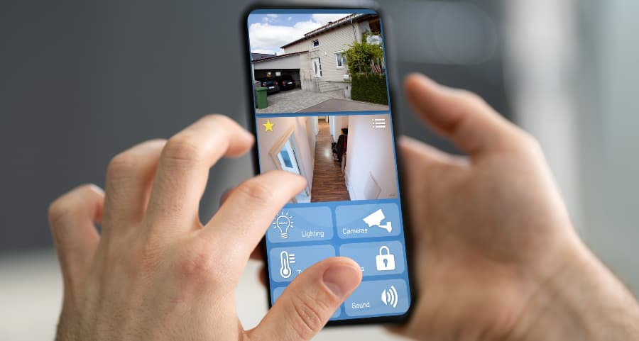 Homeowner checking surveillance camera feeds on a mobile device